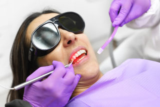 Lady in dentis chair getting laser therapy